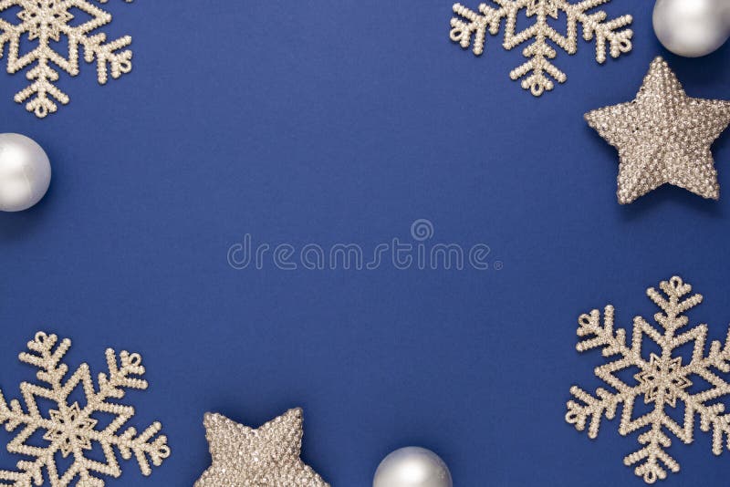 Blue abstract Christmas background frame with silver snowflakes, baubles and confetti winter decoration, blue mock up with space