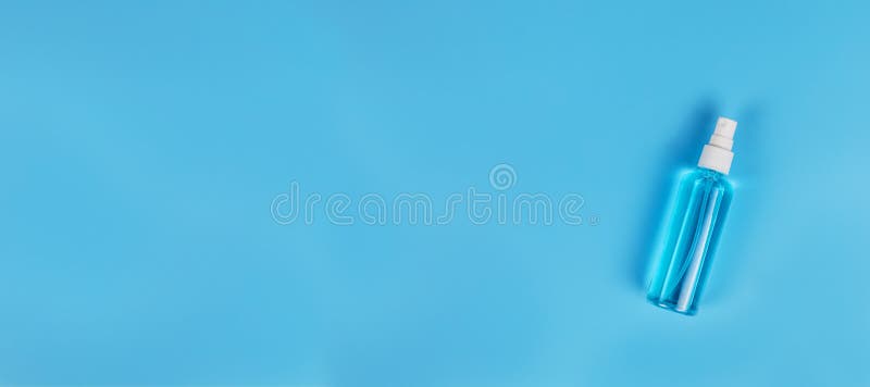 Blue alcohol isolated on blue background. Hand sanitizer for clean. Hand sanitizer in spray head bottle. with copy space stock images Blue alcohol isolated on blue background. Hand sanitizer for clean. Hand sanitizer in spray head bottle. with copy space stock images