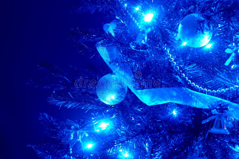 Blue background with christmas tree, ball, light.