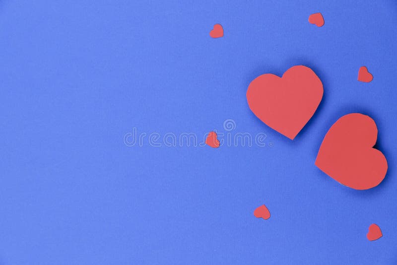 Blue background with red hearts. Valentine`s day background.