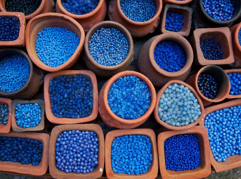 Blue beads in terra cotta pots.