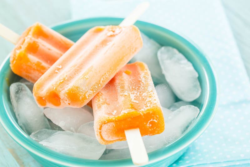 Bowl of Orange Popsicles and Ice