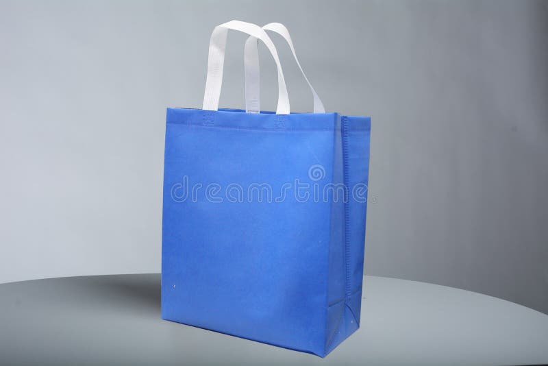 Blue Box Type Bag with white handle, PP Non Woven Fabric Shopping Bag on table