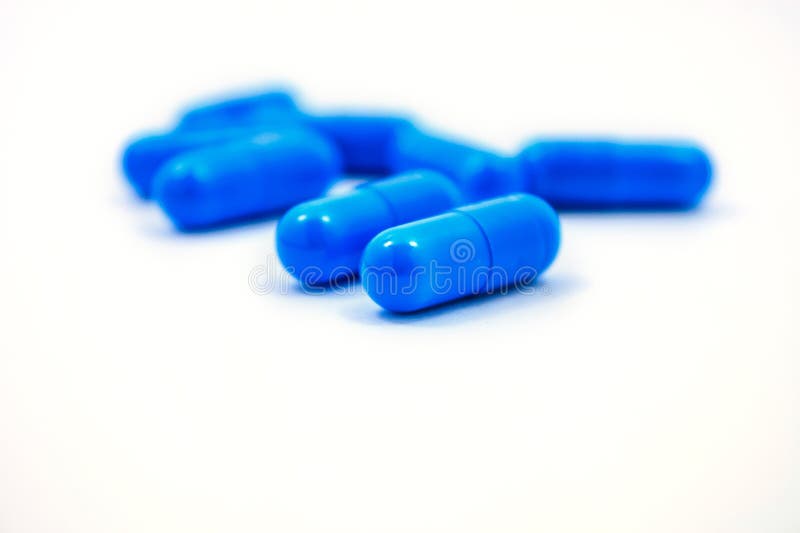 Blue capsules on a white background royalty free stock photography.