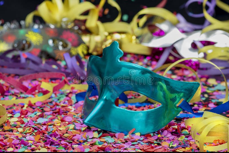 Blue Carnival Mask Over Confetti and Multicolored Streamers Stock