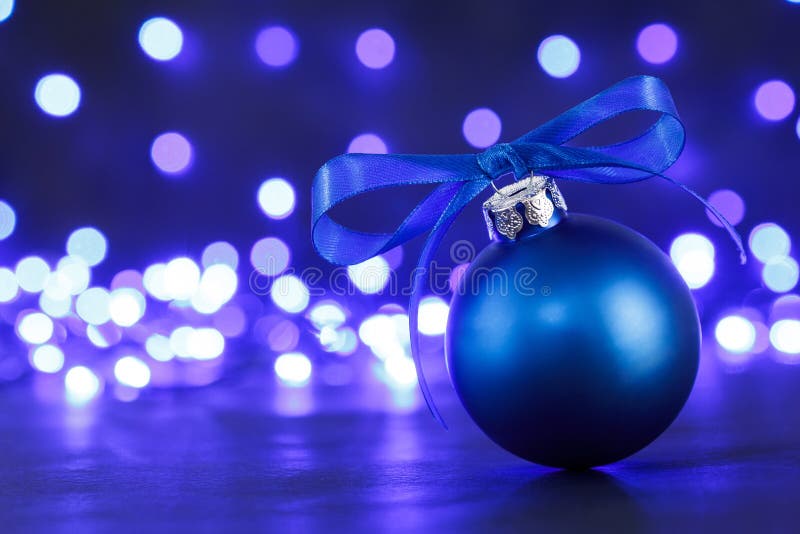 Blue Christmas Ball and Blured Purple Lights at the Background Stock