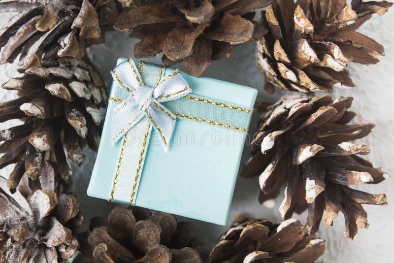 Blue Christmas gift box with pinecones, flat lay style stock images Blue Christmas gift box with pinecones, flat lay style stock images