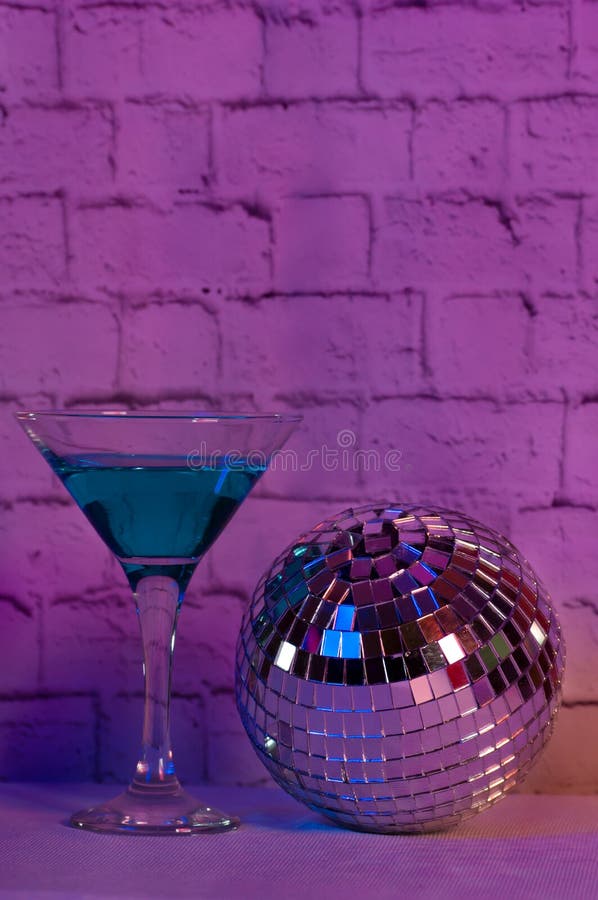 Blue Cocktail in a Glass and a Disco Ball Stock Image - Image of