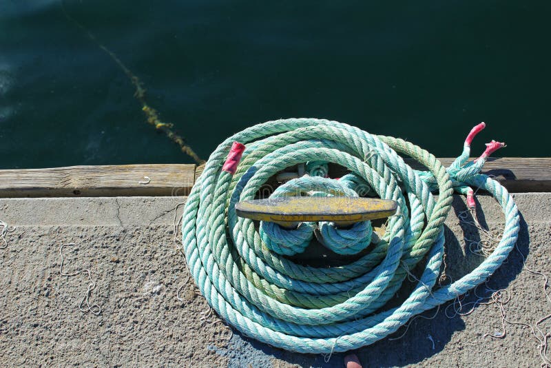 Blue coiled rope in the dock stock image Blue coiled rope in the dock stock image