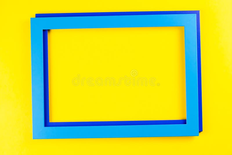 Red Color Frame on Bright Yellow and Blue Background. Stock Photo