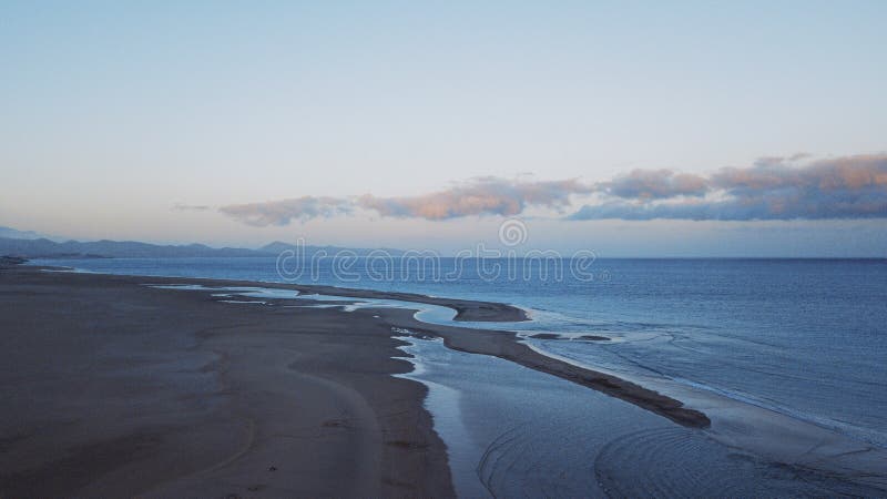 Blue colors sunset landscape at the beach with ocean and sky. Beautiful natural scenic place viewed from above. Concept of