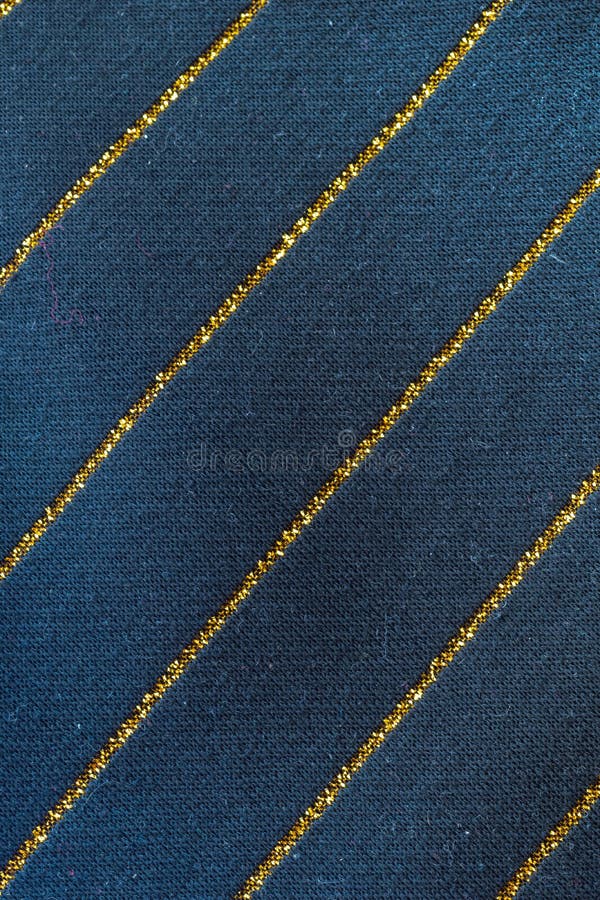 Blue cotton material with golden lines. texture or background stock photography