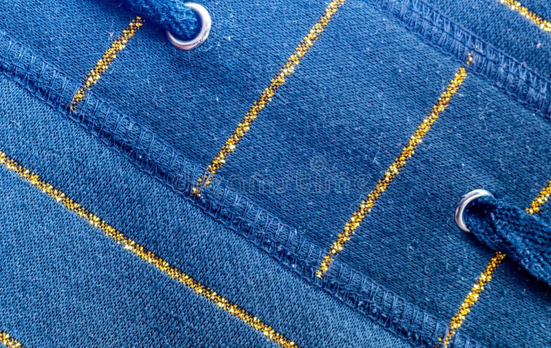 Blue cotton material with golden lines. texture or background stock photography