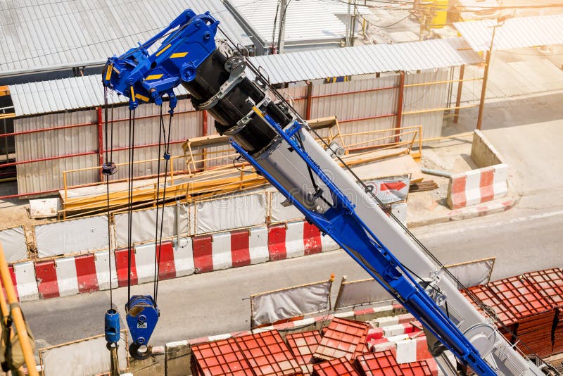Blue Crane Boom with Hooks and Sling Cable at Construction Site Stock