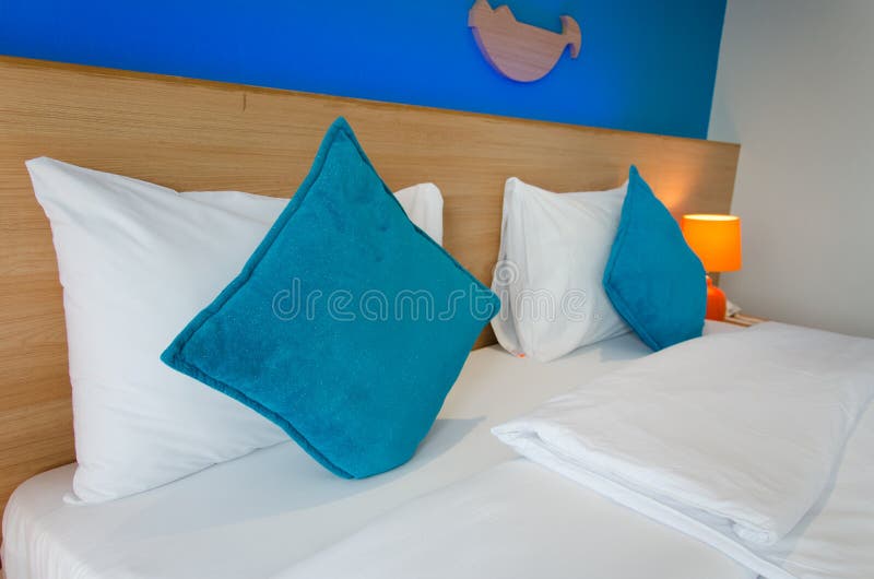 Blue pillow on the bed stock image. Image of bedding 98666789