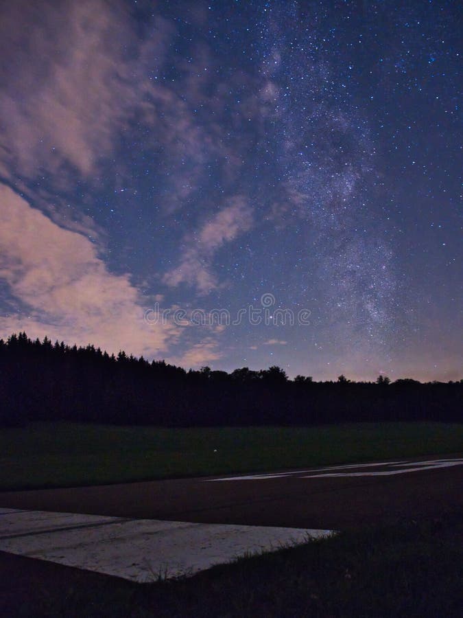 Blue dark night sky with many stars above field of trees. Milkyway cosmos background royalty free stock photo Blue dark night sky with many stars above field of trees. Milkyway cosmos background royalty free stock photo