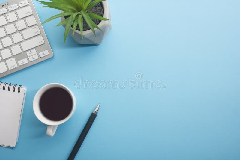 Blue desk office with laptop, smartphone and other work supplies with cup of coffee. Top view with copy space for input. The text. Designer workspace on desk royalty free stock photos
