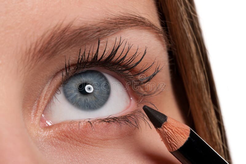 Blue eye, woman applying black make-up pencil