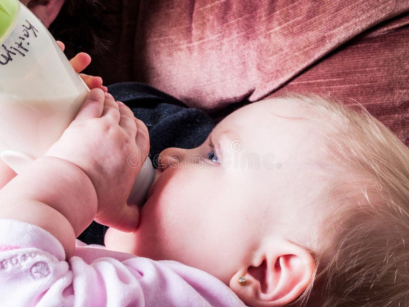 Blue-eyed Baby sucking bottle