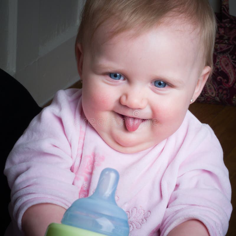 Blue-eyed Baby sucking bottle