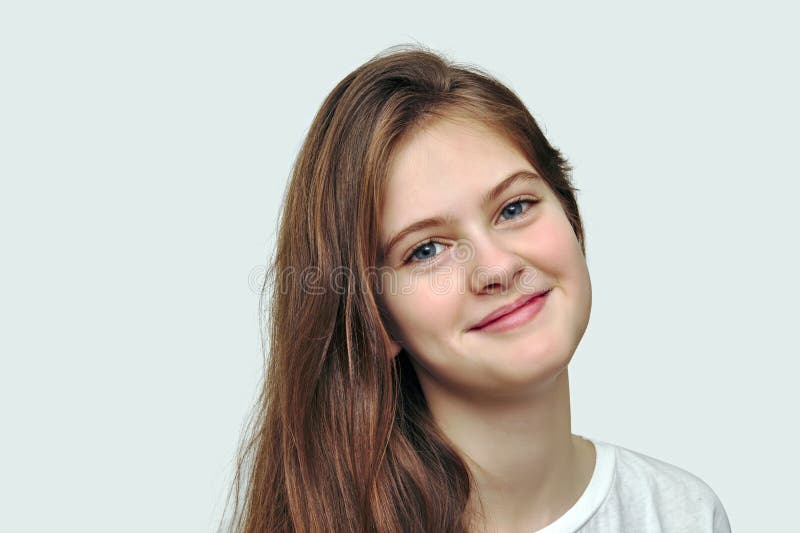 blue eyed shy girl with flowing hair. Studio model shot