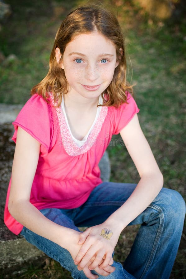 Blue eyed tween girl stock photo