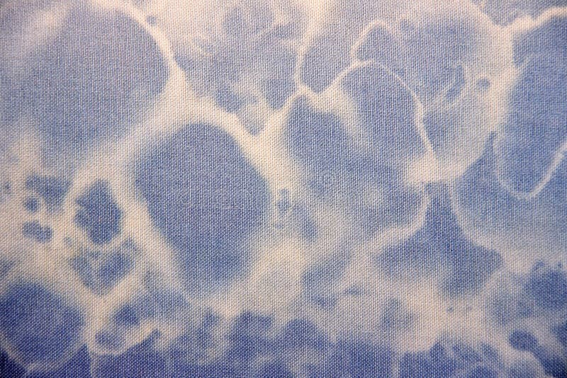 Blue fabric textur with white circles.