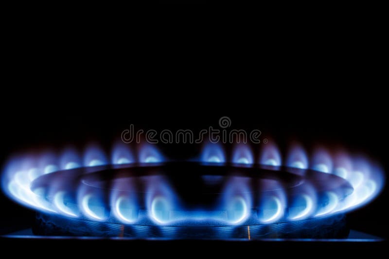 The Blue Flame of the Gas Burner of the Kitchen Stove in the Dark. Place Under the Text Stock