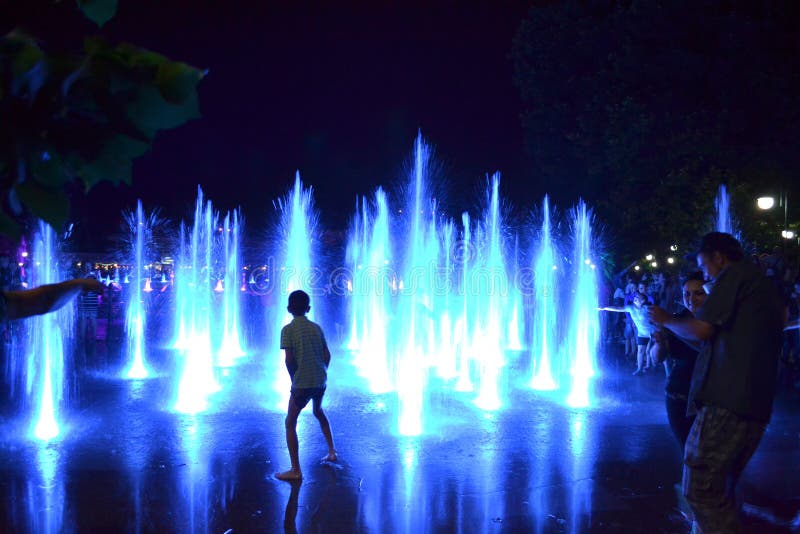 Blue fountain jets people