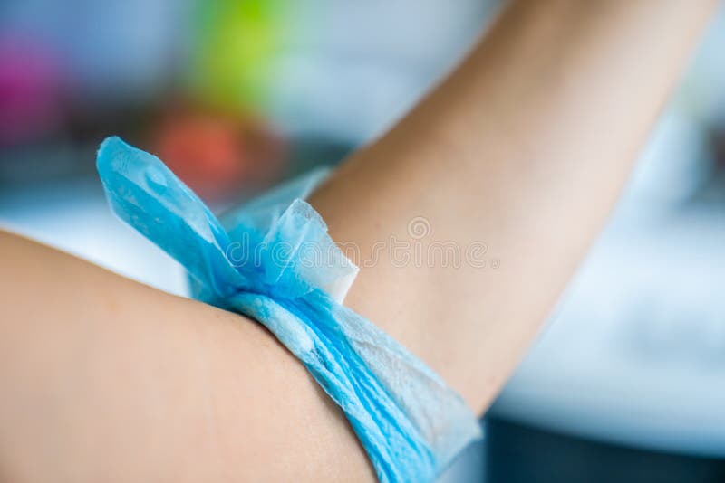 Blue gauze bandage on female arm after blood donation. stock photography Blue gauze bandage on female arm after blood donation. stock photography