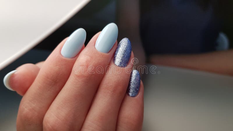 Blue gel polish nails with glitter for winter, spring or summer