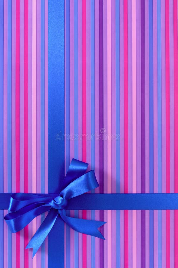 Blue Gift Ribbon Bow on Candy Stripe Wrapping Paper Background