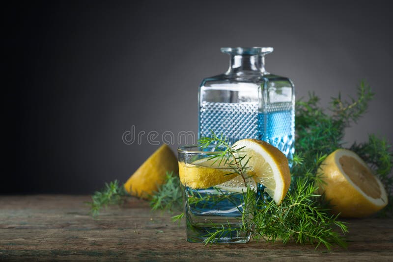 Blue gin , tonic and lemon on a old wooden table.