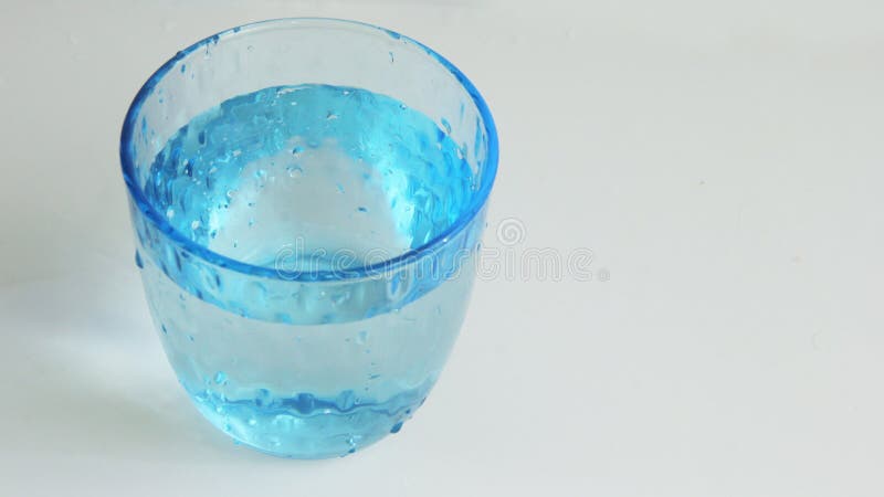 Four Beautiful Glass Cup Filled With Water In Blue Stock Photo, Picture and  Royalty Free Image. Image 8160433.