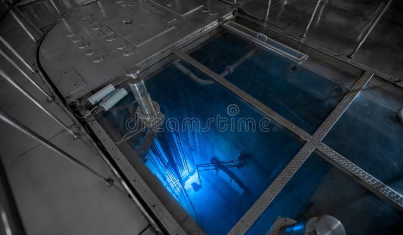 Blue glow water of nuclear reactor core powered, caused by Cherenkov radiation, fuel plates industrial uran