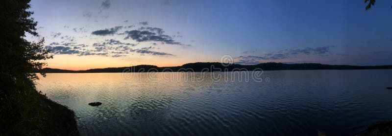 Blue and Gold Sunset on Lake with Mountains