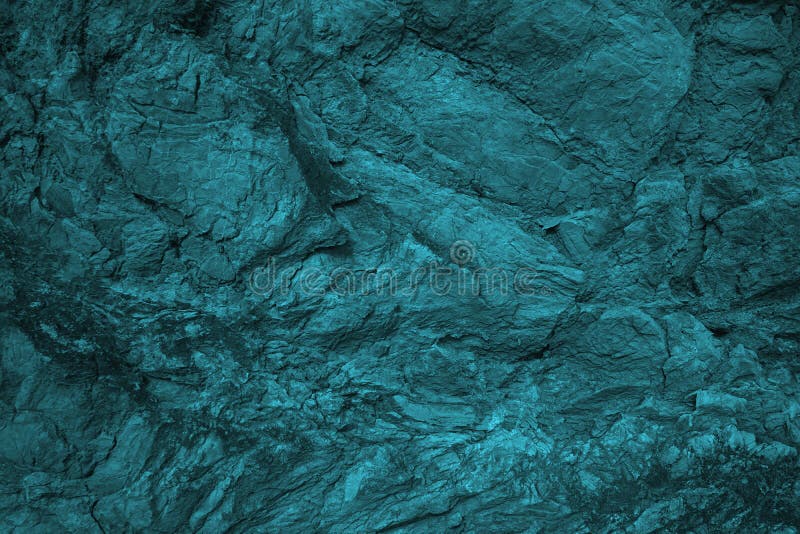 Blue green grunge background. Toned rock texture background. Combination of teal color and rough cracked stone surface. Tidewater
