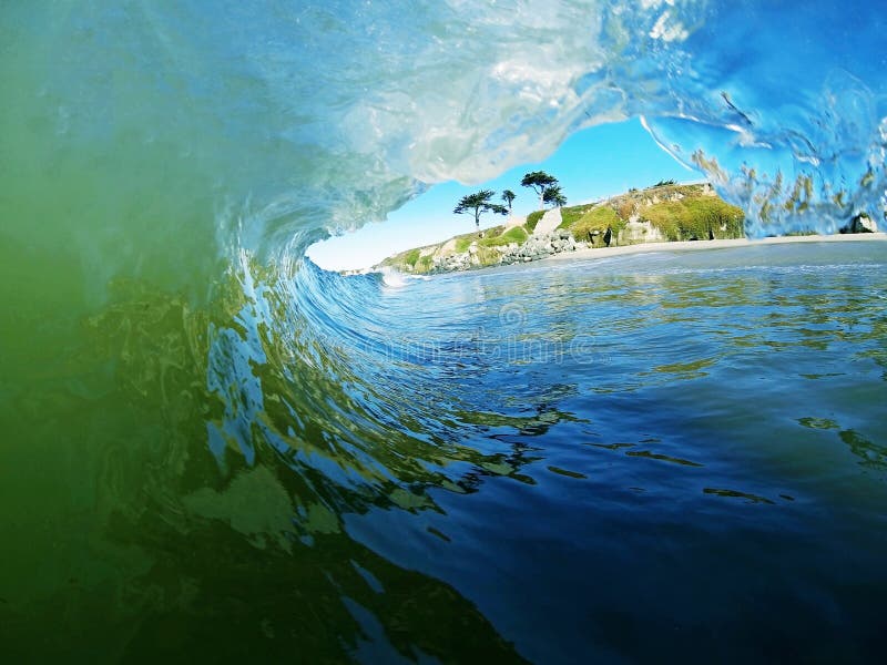 A Blue and Green Ocean Wave Breaks Near the Beach royalty free stock photography A Blue and Green Ocean Wave Breaks Near the Beach royalty free stock photography