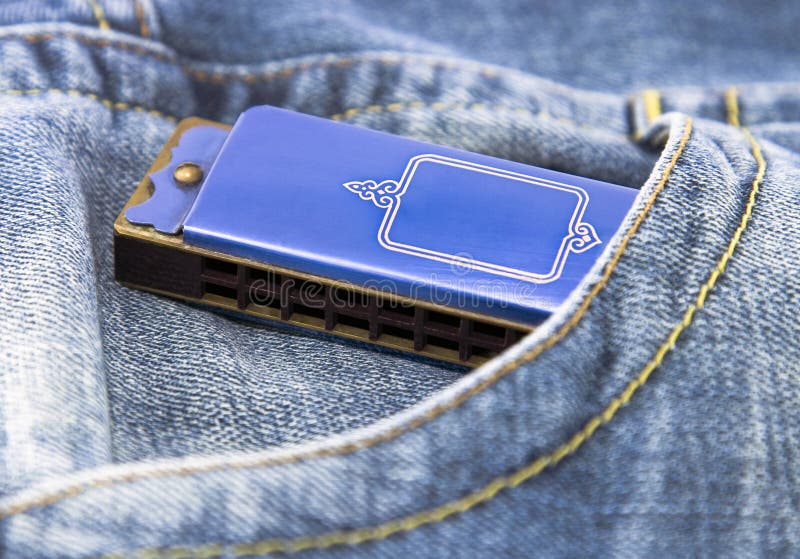 Blue harmonica in blue jeans pocket