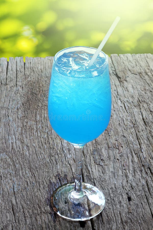 Blue Hawaii cocktail on wooden table.