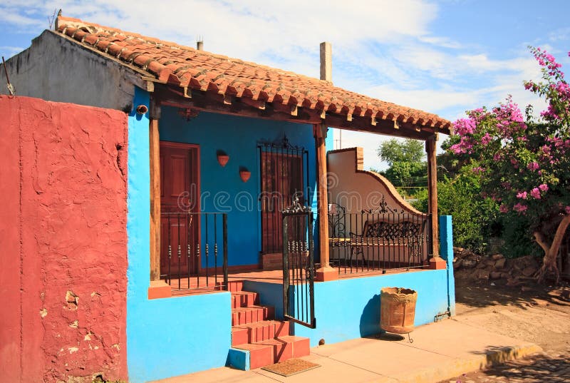 Blue house with bright red wall stock photos