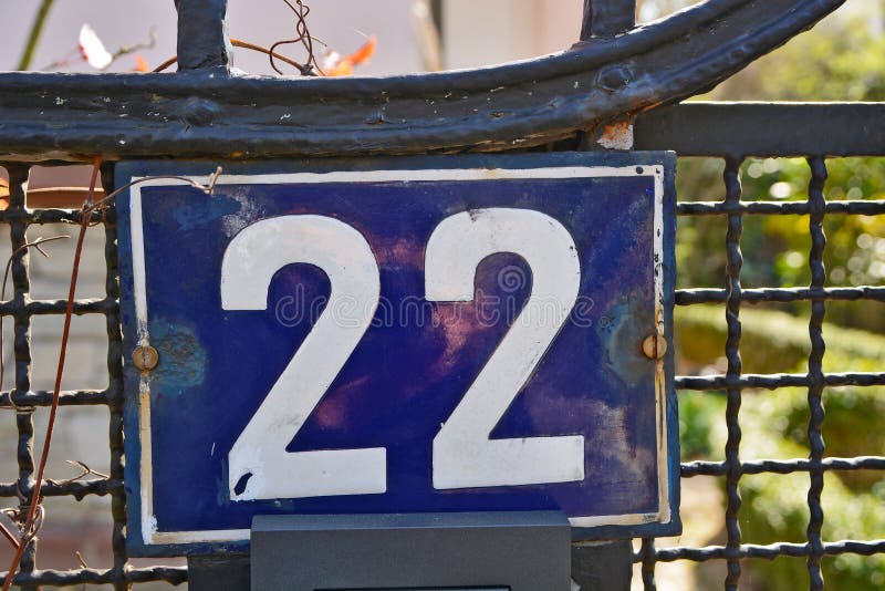 A Blue House Number Plaque, Showing the Number SixteenA Blue House