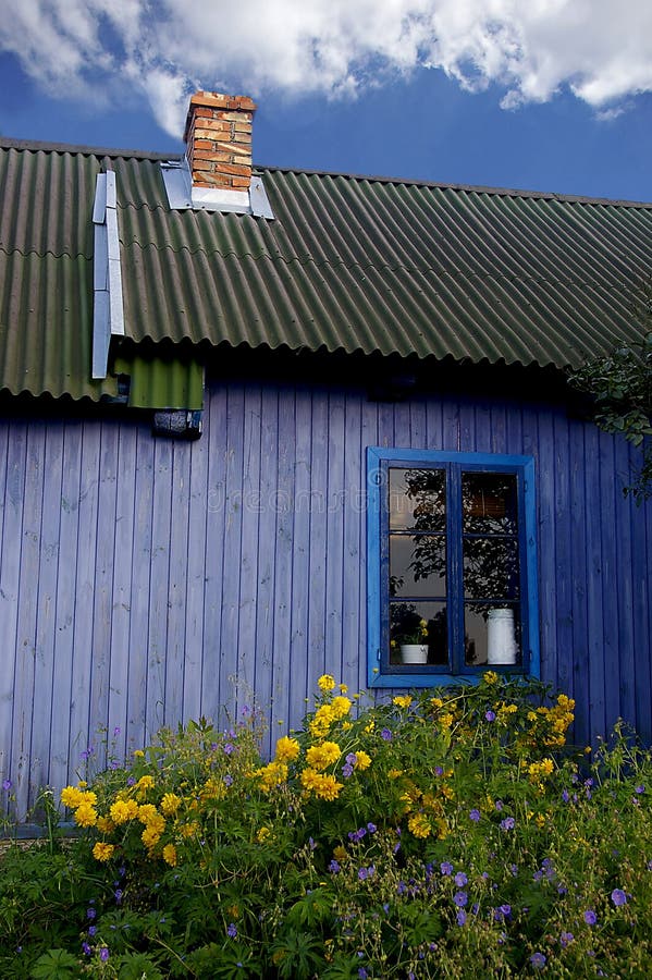 Blue hut with yellow flowers