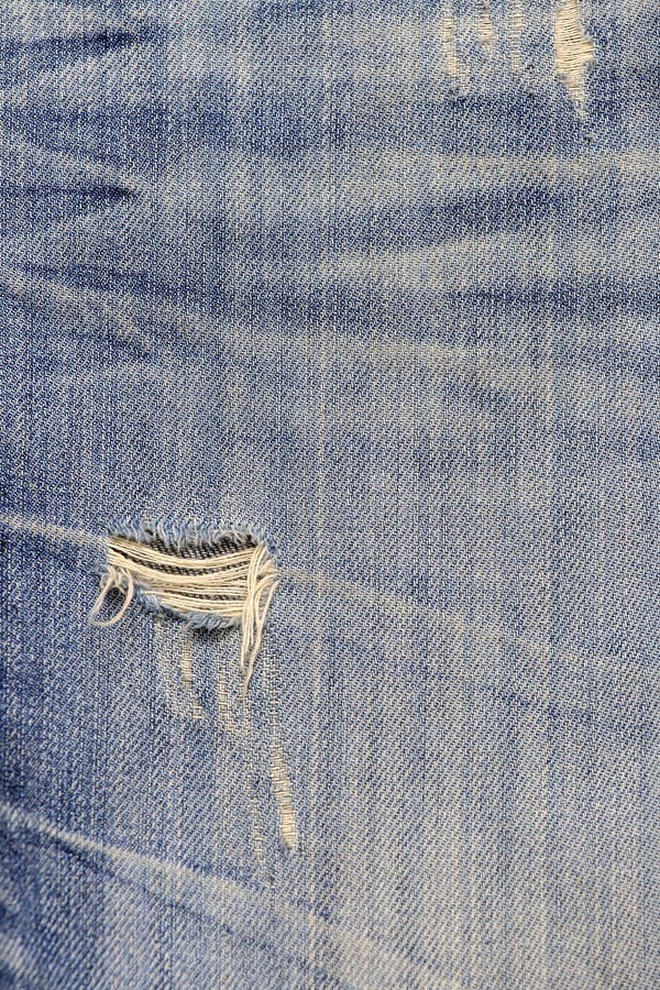 Blue Jean Texture with a Hole and Threads Showing Stock Photo - Image ...