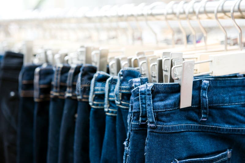 Blue Jeans Denim Clothing Hanged On The Rack Stock Image - Image of ...