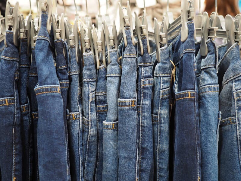 Blue Jeans Pants in a Hanger, Closeup Stock Image - Image of stack ...