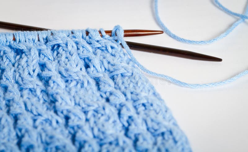 Blue knit with rose-wood knitting needles