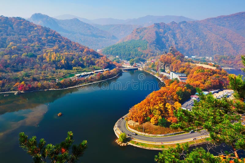 The blue lake and autumn forest hills