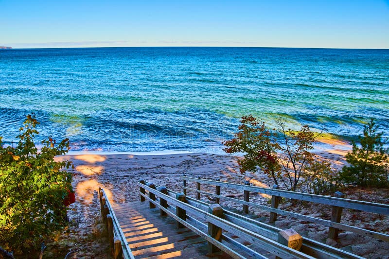 Blue Lake or Ocean with Stair Walkway Down To Shore Stock Photo Image