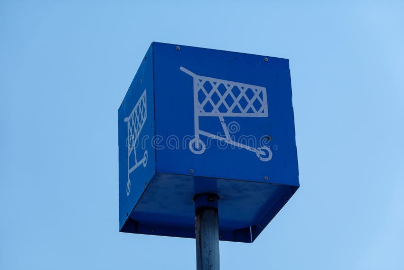Blue Metal Box on a Metal Pole that Has a Drawing of a Shopping Cart on